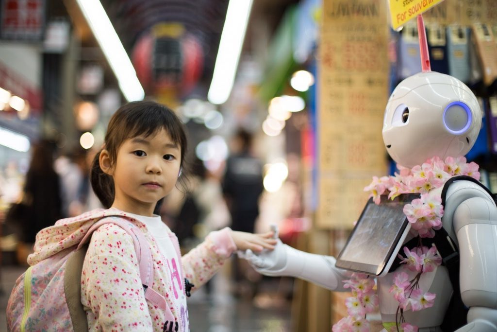 Image of a girl holding hand of robot