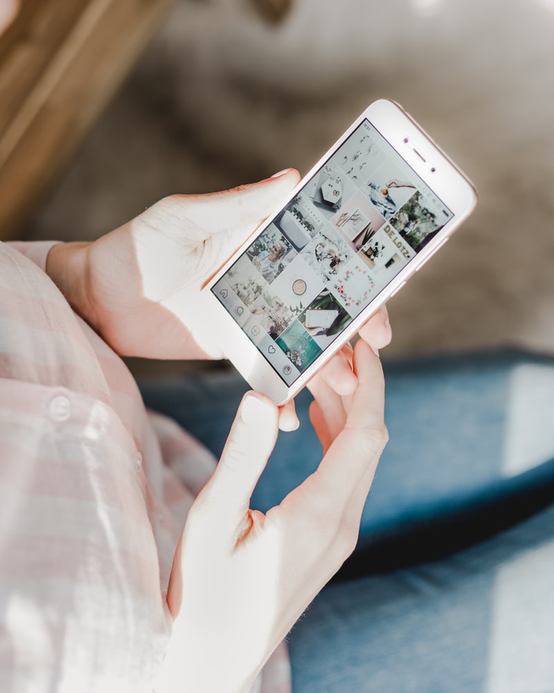 Stock image of person using phone displaying Instagram