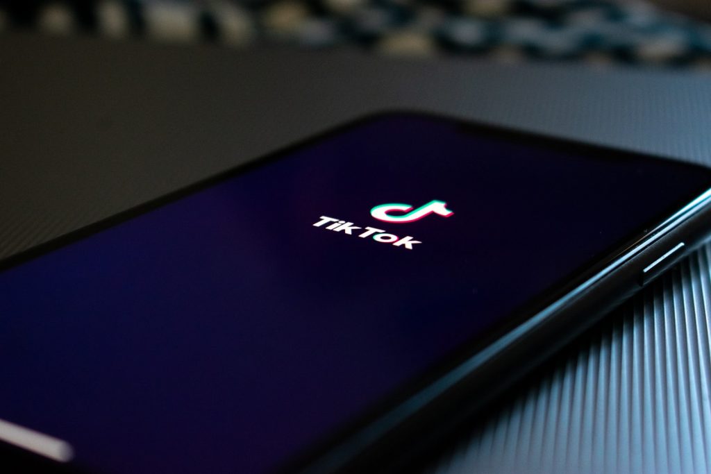 Stock image of phone displaying TikTok logo