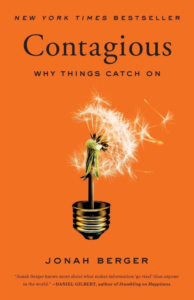 Dark orange cover of Contagious, a digital marketing book, with a dandelion positioned above a lightbulb