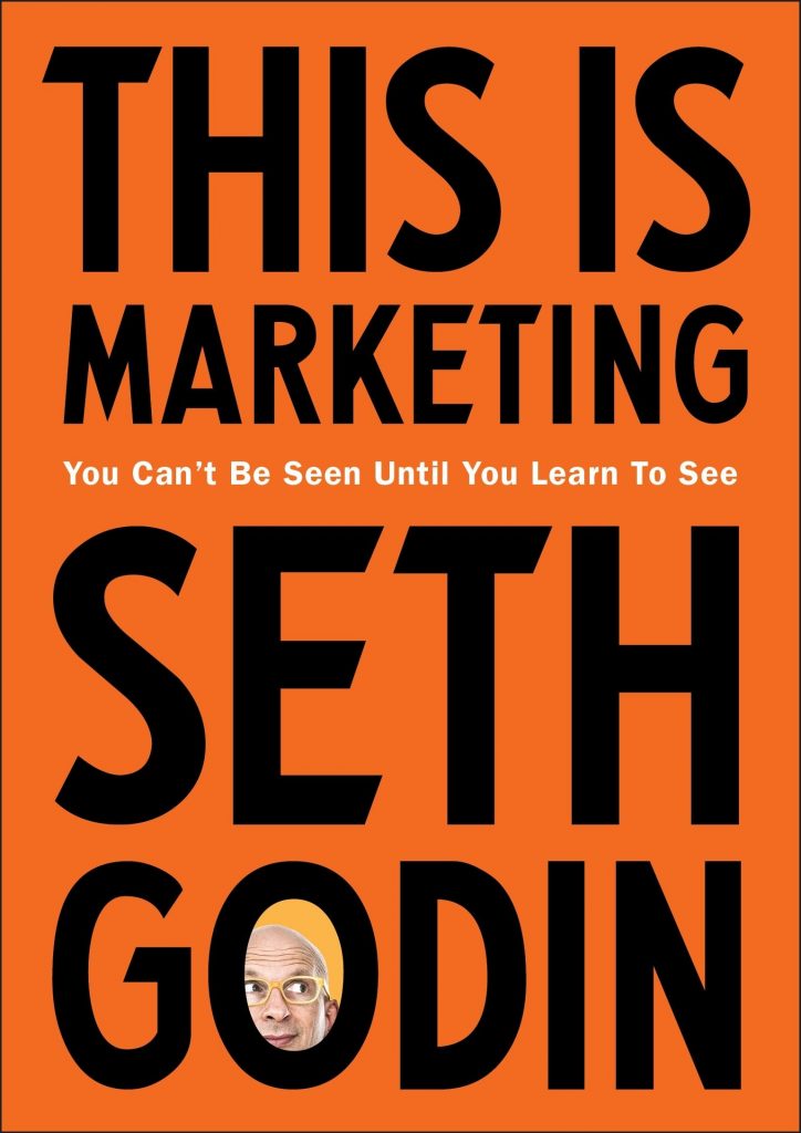This Is Marketing, by Seth Godin, a digital marketing book. Orange cover, black text.