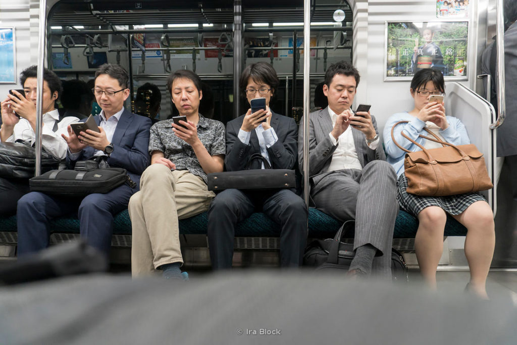 People with cell phones in a train in Tokyo, Japan