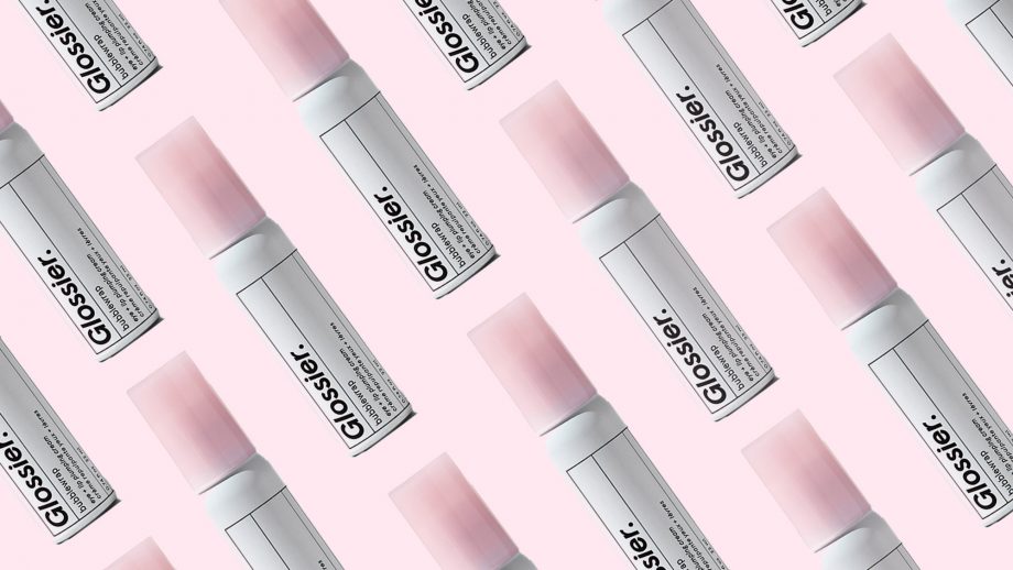 Glossier's products against a pink background