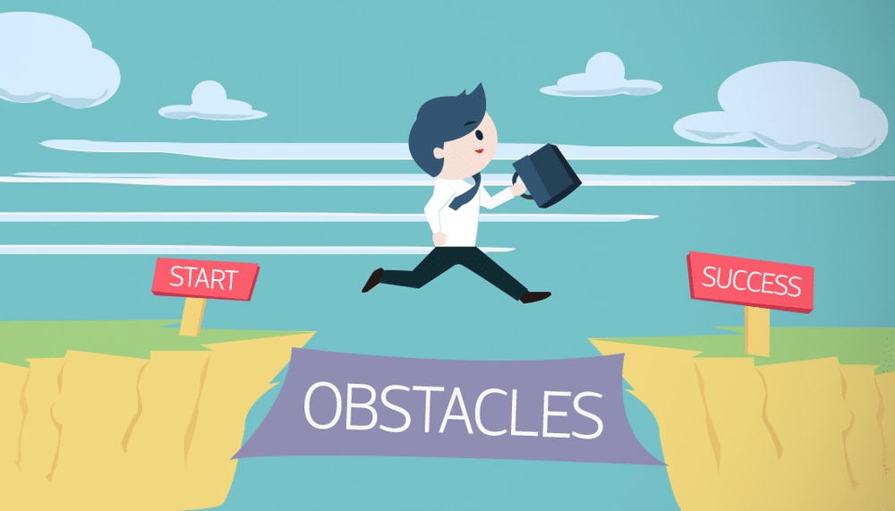 Stock image of man jumping from 'start', over gap labelled 'obstacles' to 'success'