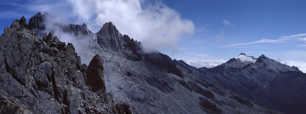 Landscape shot of grey mountain range and blue sky